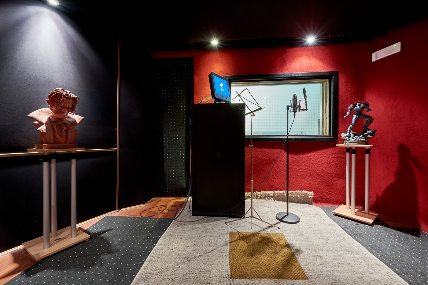 Sound recording booth with microphone and isolation window