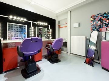 Make-up and styling room with two chairs and lit mirrors